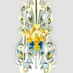 Handgeschnitzte weiße Kerze mit filigranen blauen, gelben und goldfarbenen Akzenten und einer Venezianischer Karnevalmaske im Zentrum.